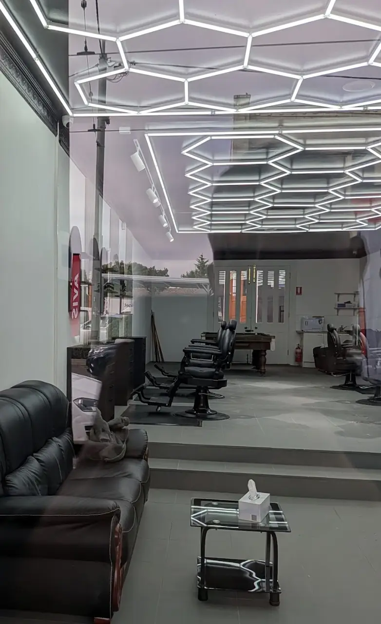 Inside GKF Barber, under its hexagon light ceiling